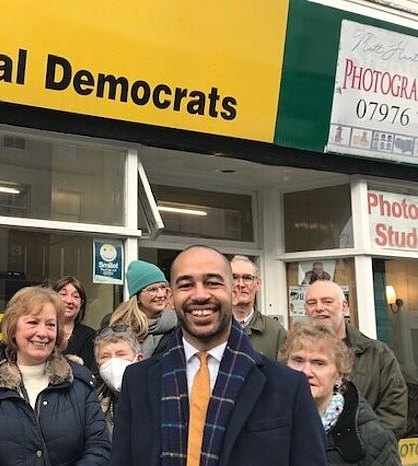 Josh Babarinde MP with local Liberal Democrat supporters outside the party office in Eastbourne